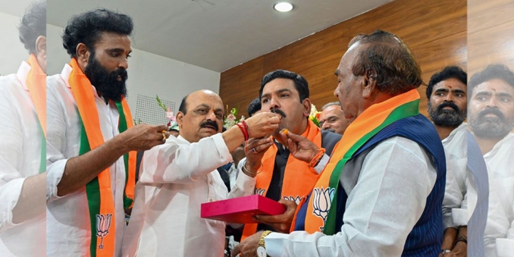 Bengaluru: Former Karnataka chief minister Basavaraj Bommai offers sweets to newly appointed State BJP President B.Y. Vijayendra during the charge taking funtion at party office, in Bengaluru, Wednesday, Nov. 15, 2023. (PTI Photo)(PTI11_15_2023_000392B)